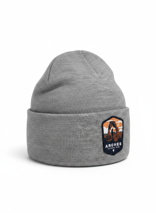 Moove Headwear grey knit beanie with Arches National Park patch featuring Delicate Arch and a hiker.