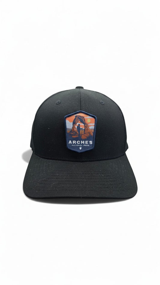 Moove Headwear black fitted baseball cap with Arches National Park patch featuring Delicate Arch and a hiker.