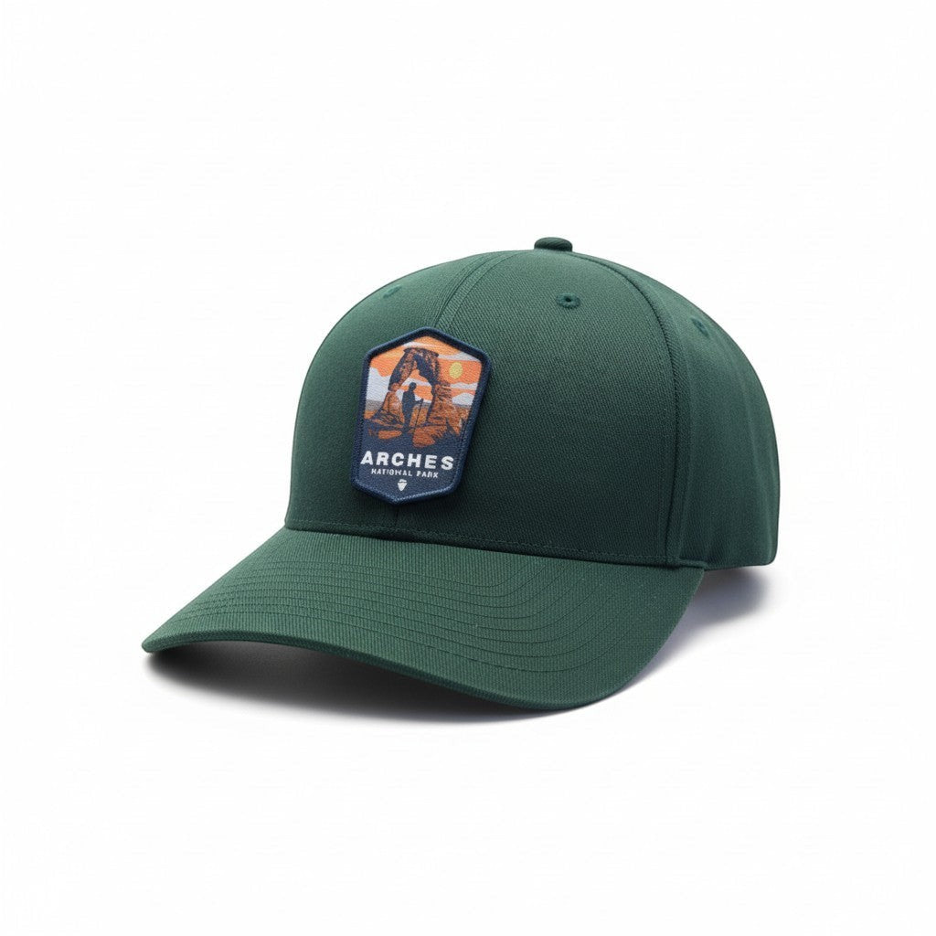 Moove Headwear dark green fitted baseball cap with Arches National Park patch and desert landscape graphic.