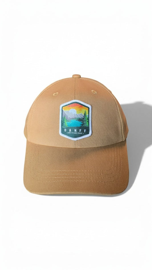 Moove Headwear Banff National Park embroidered baseball cap in tan with adjustable strap and mountain landscape patch.