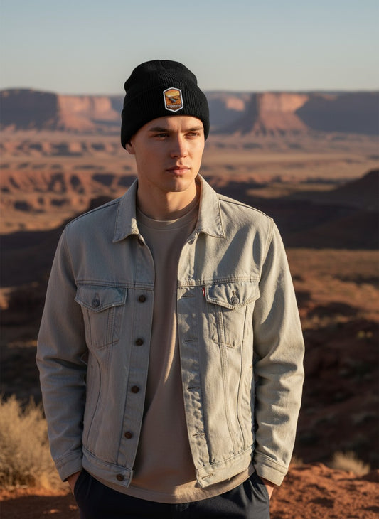 Moove Headwear black rib-knit beanie with Canyonlands National Park patch worn by a man in a desert landscape