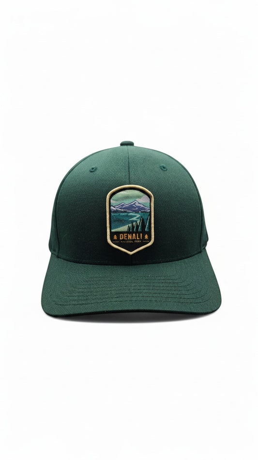 Moove Headwear dark green fitted baseball cap with Denali National Park embroidered patch featuring mountains and trees.