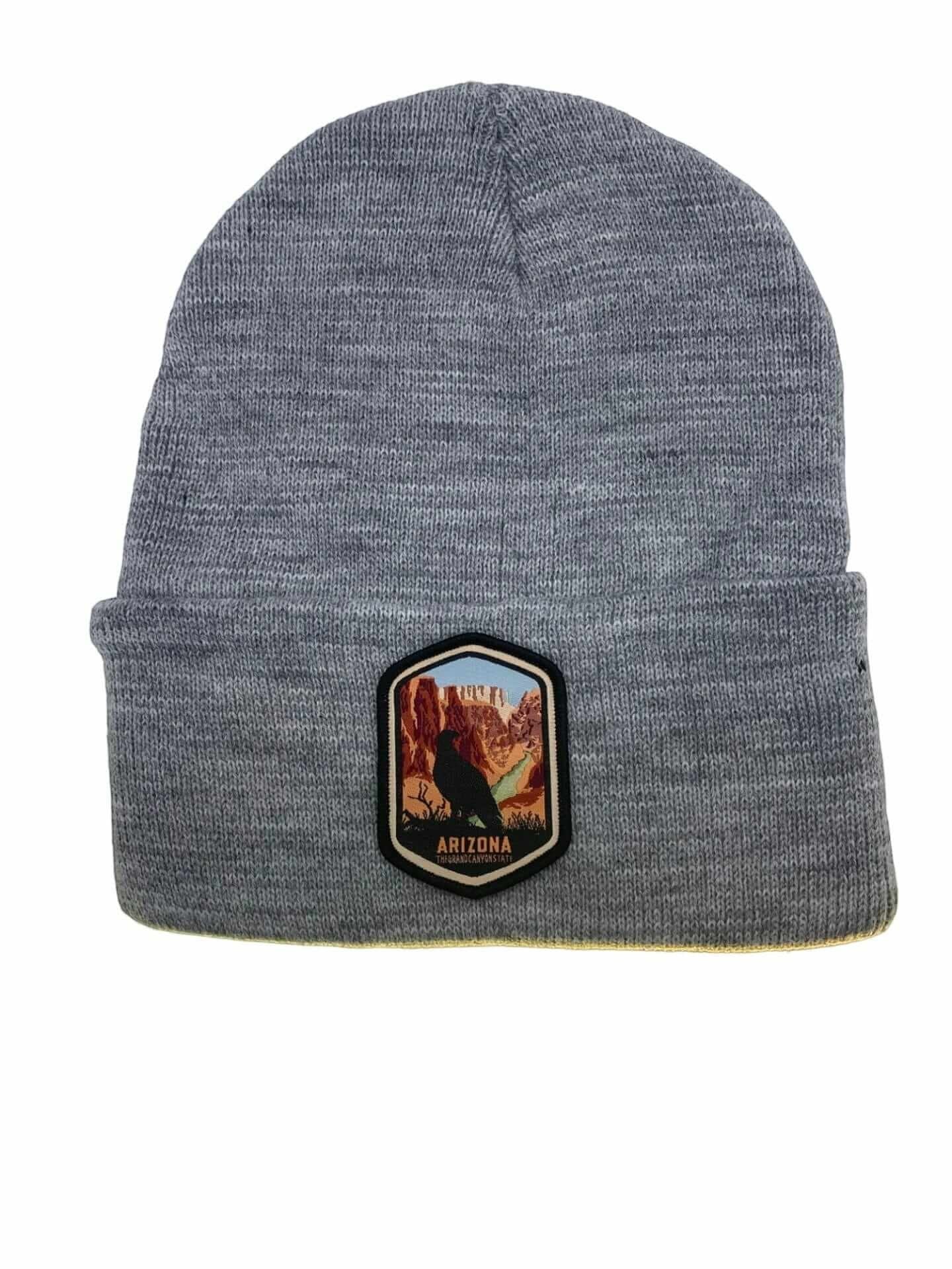Moove Headwear grey acrylic rib-knit beanie with a woven patch featuring a bird and the Grand Canyon.