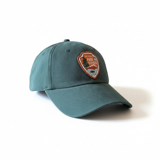 Moove Headwear teal adjustable dad hat with embroidered National Park Service emblem on front.