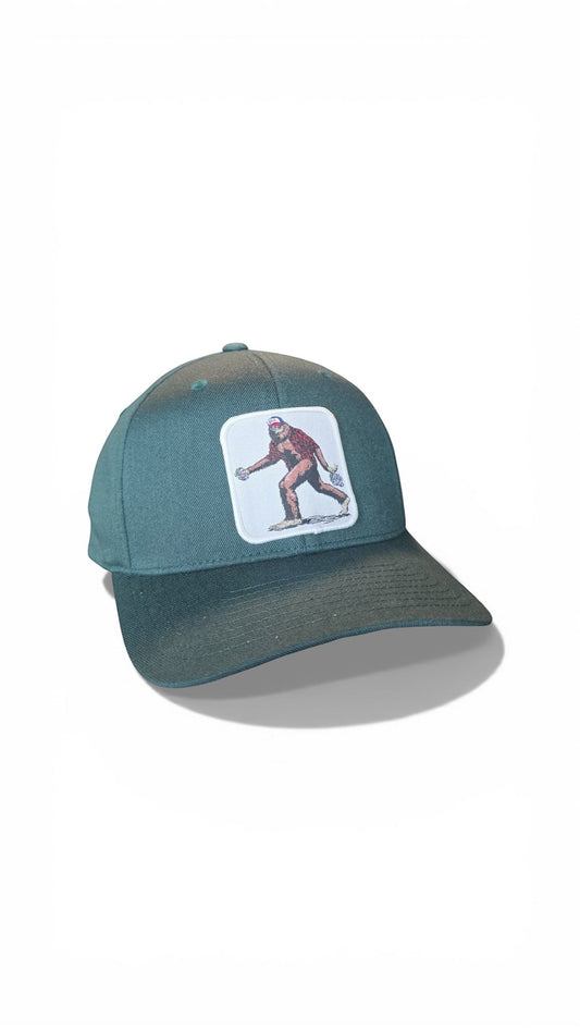 Moove Headwear teal baseball cap with embroidered Sasquatch graphic. Fitted dad hat style.