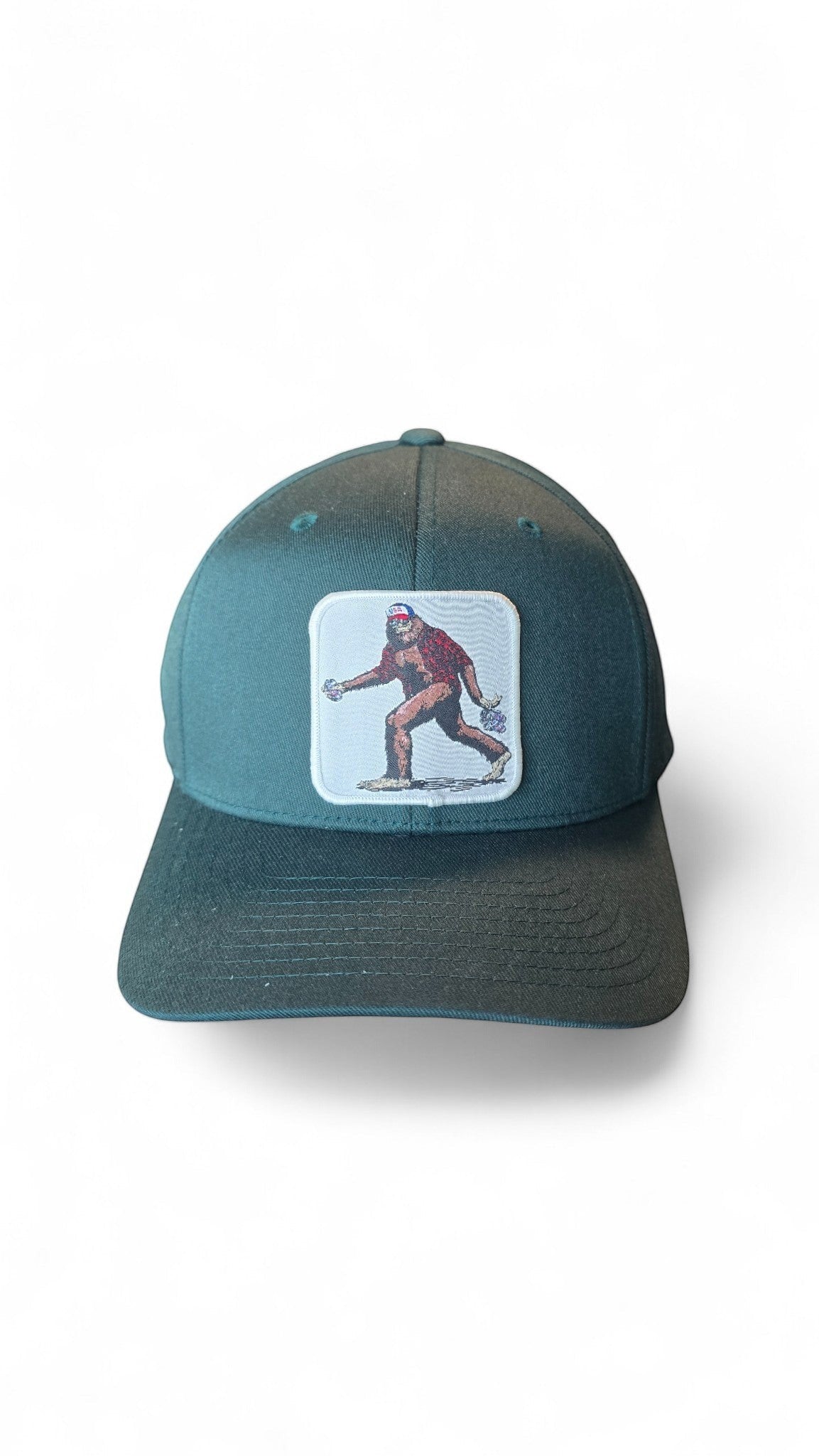 Moove Headwear dark teal baseball cap with a Bigfoot embroidered patch. Fitted dad hat style.