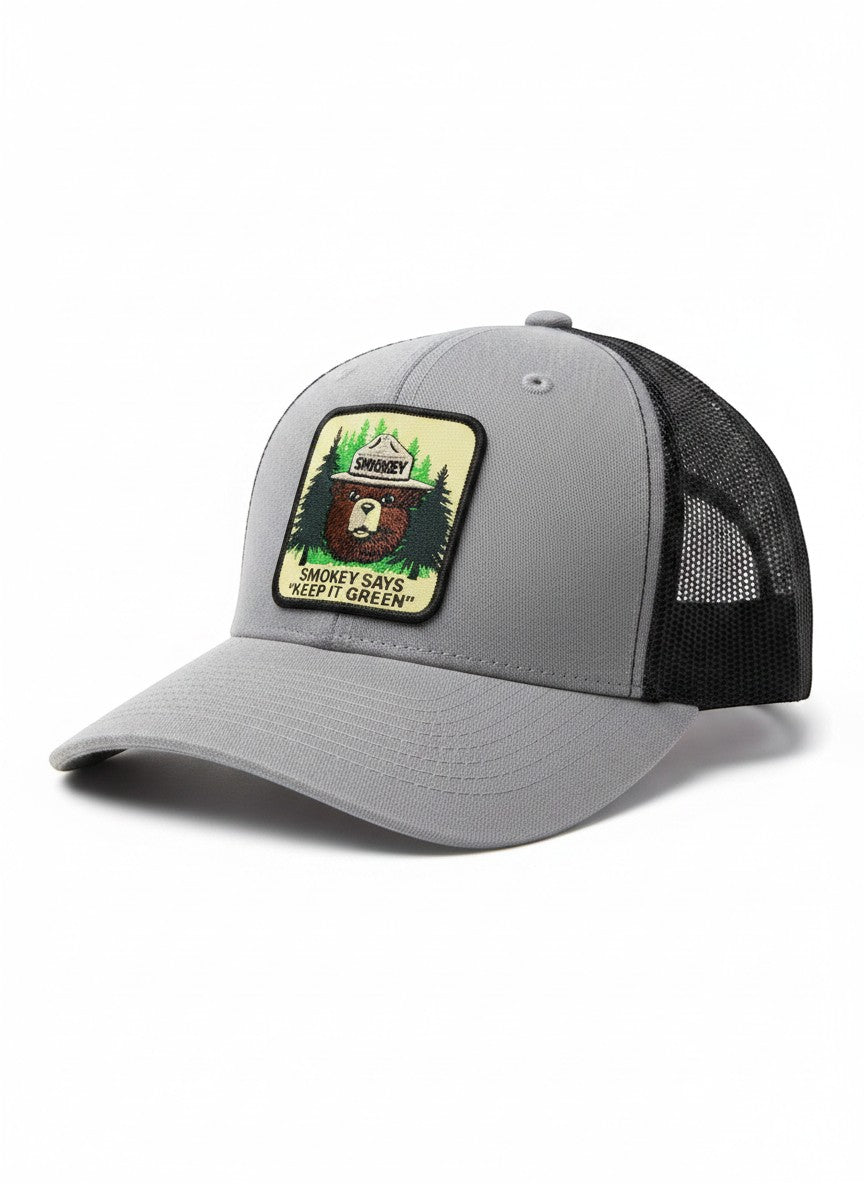 Moove Headwear grey trucker hat with black mesh back and Smokey Bear patch saying "Keep It Green"
