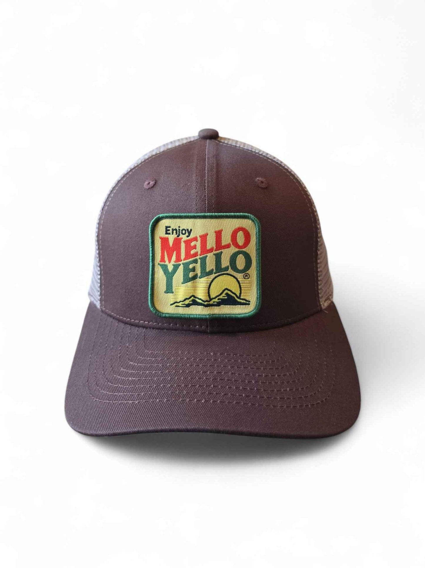 Brown and tan retro trucker hat with vintage Mello Yello patch, mesh back, and snapback closure
