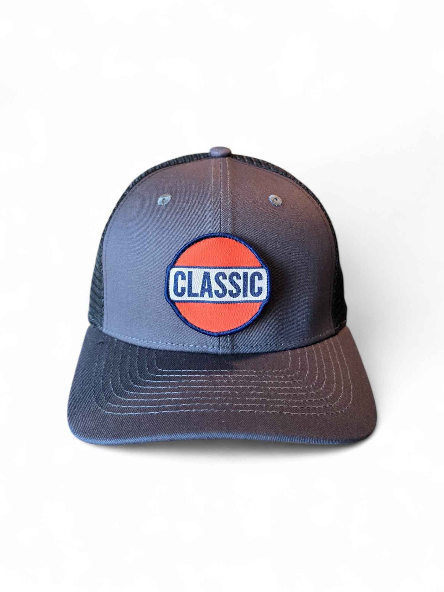 Gray and black retro trucker hat with Classic patch, mesh back, and snapback closure