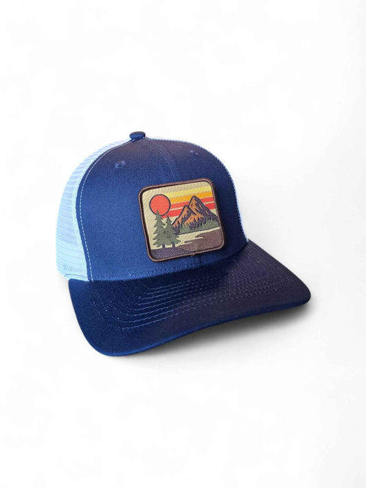 Navy blue and white retro trucker cap with vintage Mello Yello patch and adjustable mesh back