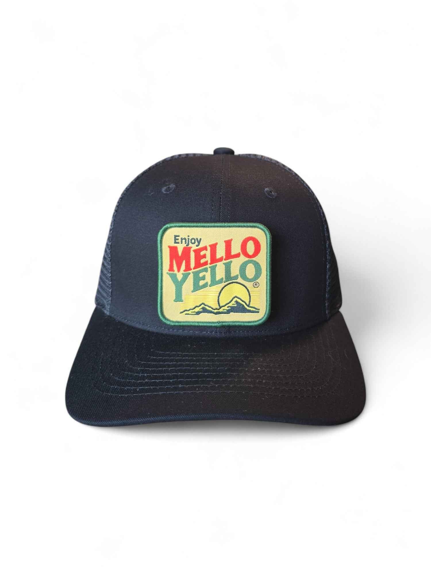 All black retro trucker hat with classic Mello Yello patch, mesh back, and snapback fit