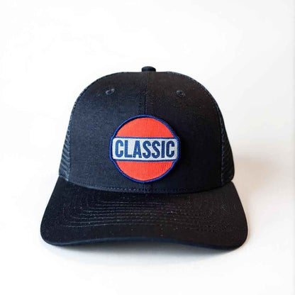 All black retro trucker hat with bold red, white, and blue Classic patch