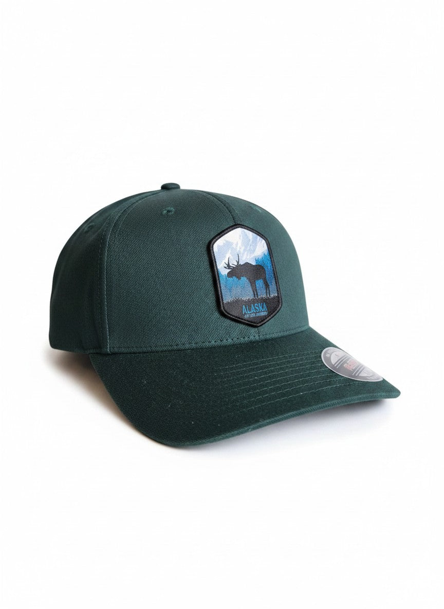 Moove Headwear dark green fitted hat with embroidered Alaska moose and mountain patch.