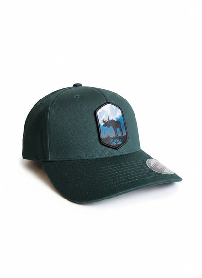 Moove Headwear dark green fitted hat with embroidered Alaska moose and mountain patch.