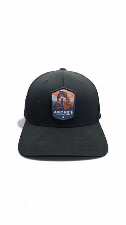 Moove Headwear black fitted baseball cap with Arches National Park patch featuring Delicate Arch and a hiker.