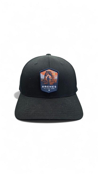 Moove Headwear black fitted baseball cap with Arches National Park patch featuring Delicate Arch and a hiker.