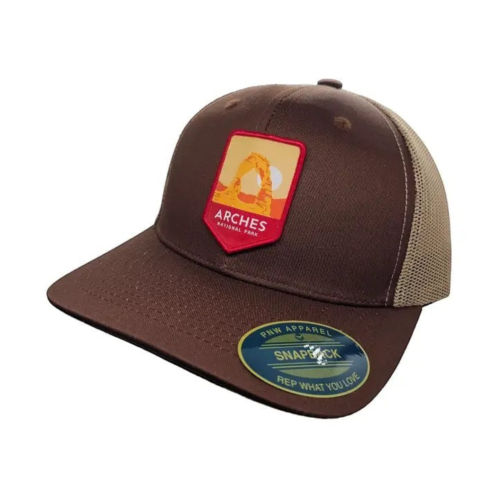 Moove Headwear brown trucker hat with Arches National Park patch and tan mesh back. Adjustable fit.