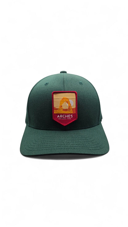 Moove Headwear Arches National Park baseball cap in dark green with embroidered patch of Delicate Arch. Adjustable fit.
