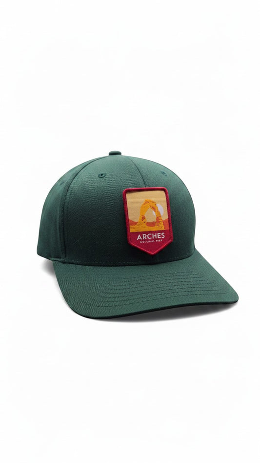 Moove Headwear Arches National Park baseball cap in dark green with embroidered patch. Adjustable fit, unisex.