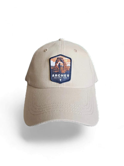 Moove Headwear tan baseball cap with Arches National Park embroidered patch, adjustable brass buckle closure.