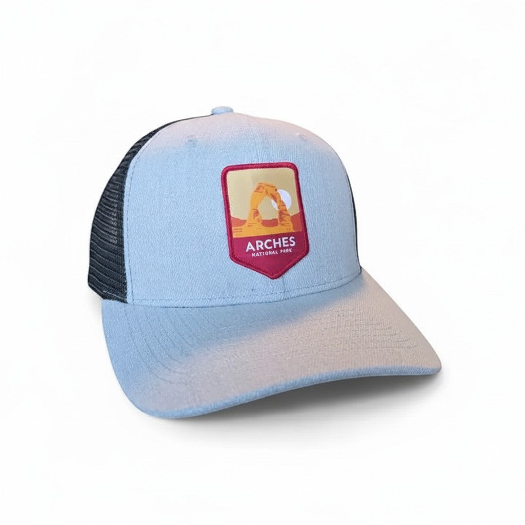 Moove Headwear light blue trucker hat with Arches National Park embroidered patch and mesh back.