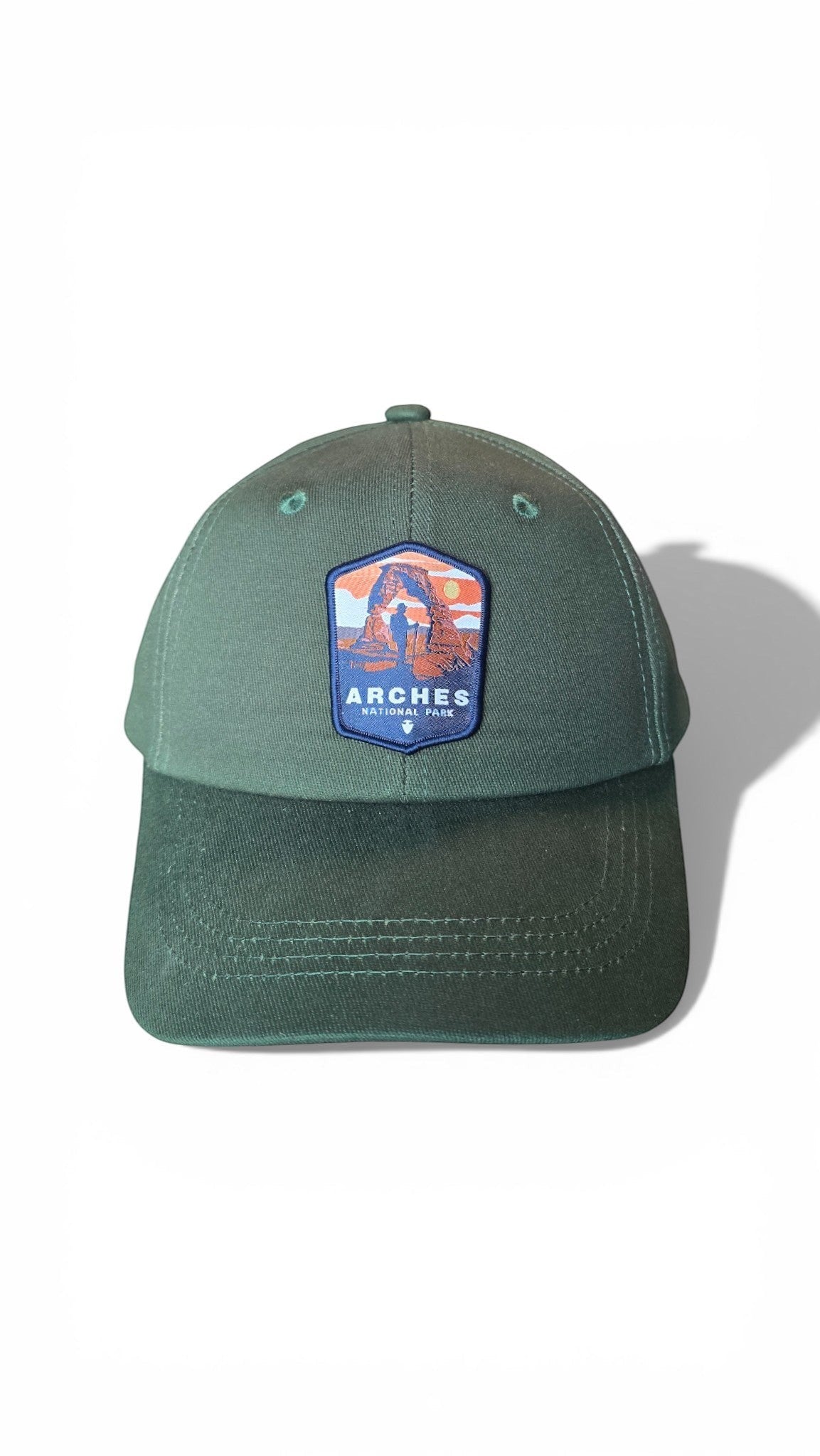 Moove Headwear green cotton baseball cap with Arches National Park patch, adjustable brass buckle closure.