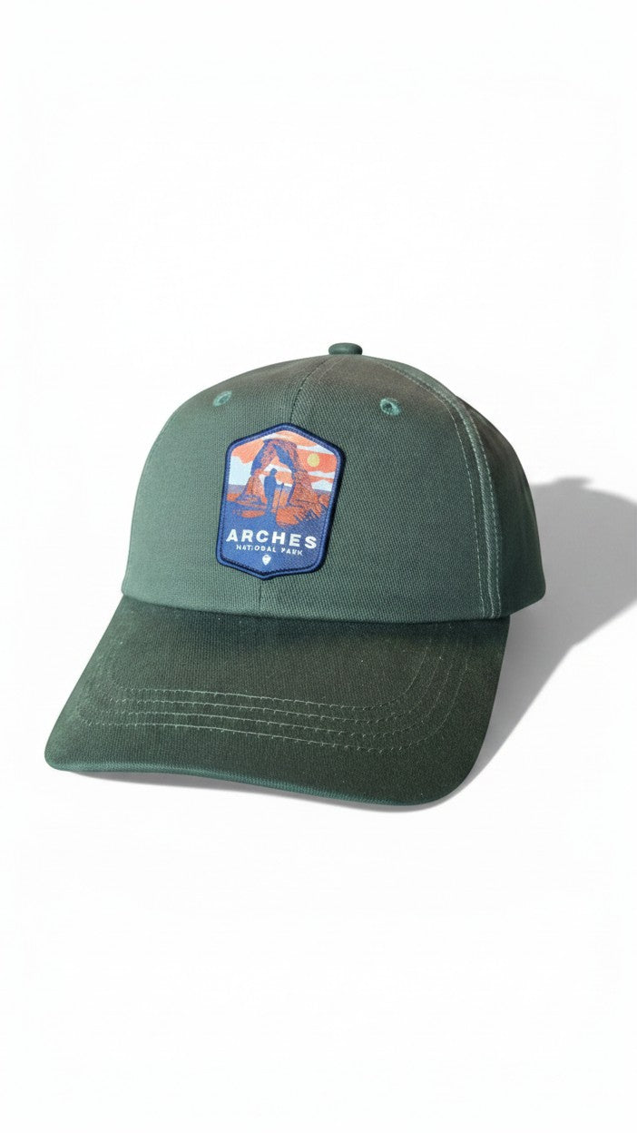 Moove Headwear green cotton baseball cap with Arches National Park patch, adjustable brass buckle closure.