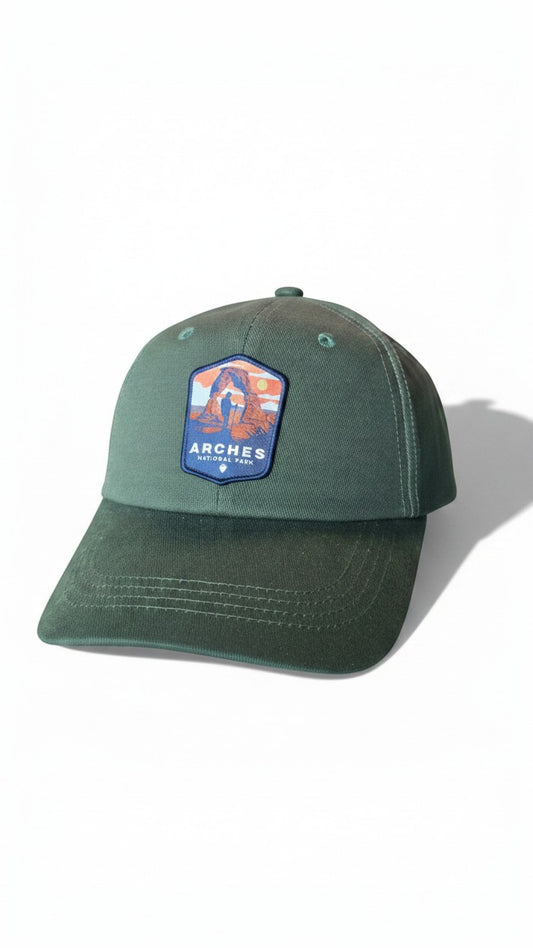 Moove Headwear green cotton baseball cap with Arches National Park patch, adjustable brass buckle closure.