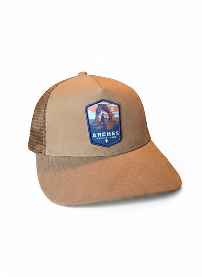 Moove Headwear tan suede trucker hat with mesh back and Arches National Park embroidered patch.