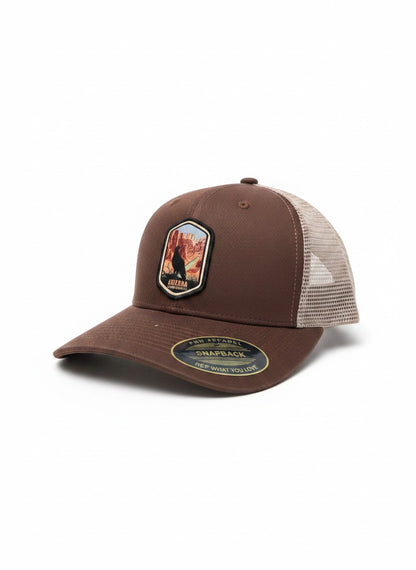 Moove Headwear brown trucker hat with embroidered Arizona desert patch and mesh back. Adjustable snapback.