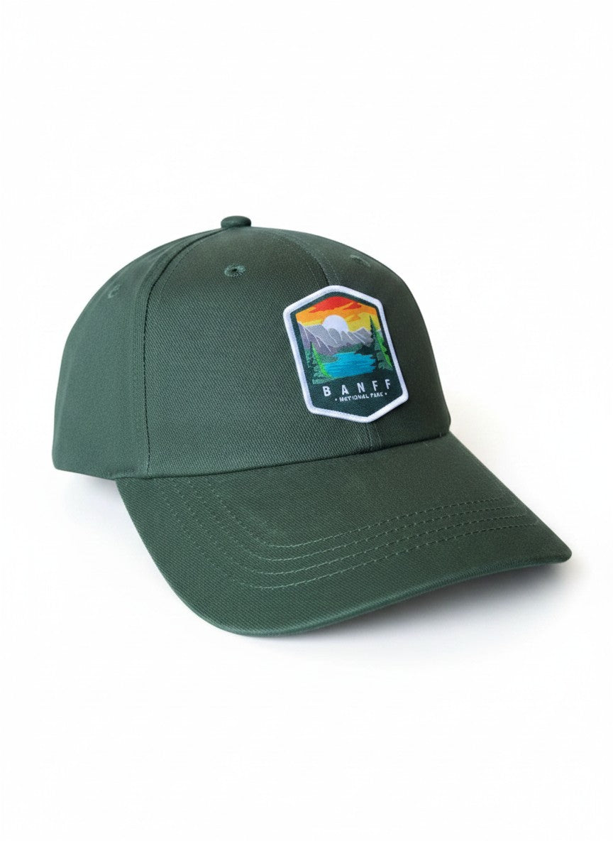 Moove Headwear dark green baseball cap with embroidered Banff National Park logo patch. Adjustable strap.