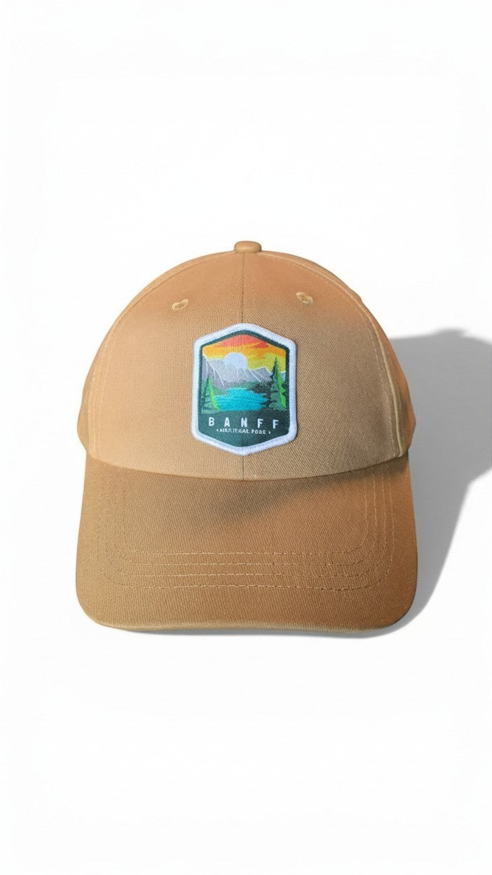 Moove Headwear Banff National Park embroidered baseball cap in tan with adjustable strap and mountain landscape patch.