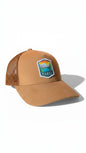 Moove Headwear Banff National Park trucker hat in tan suede with embroidered mountain lake scene patch. Mesh back.