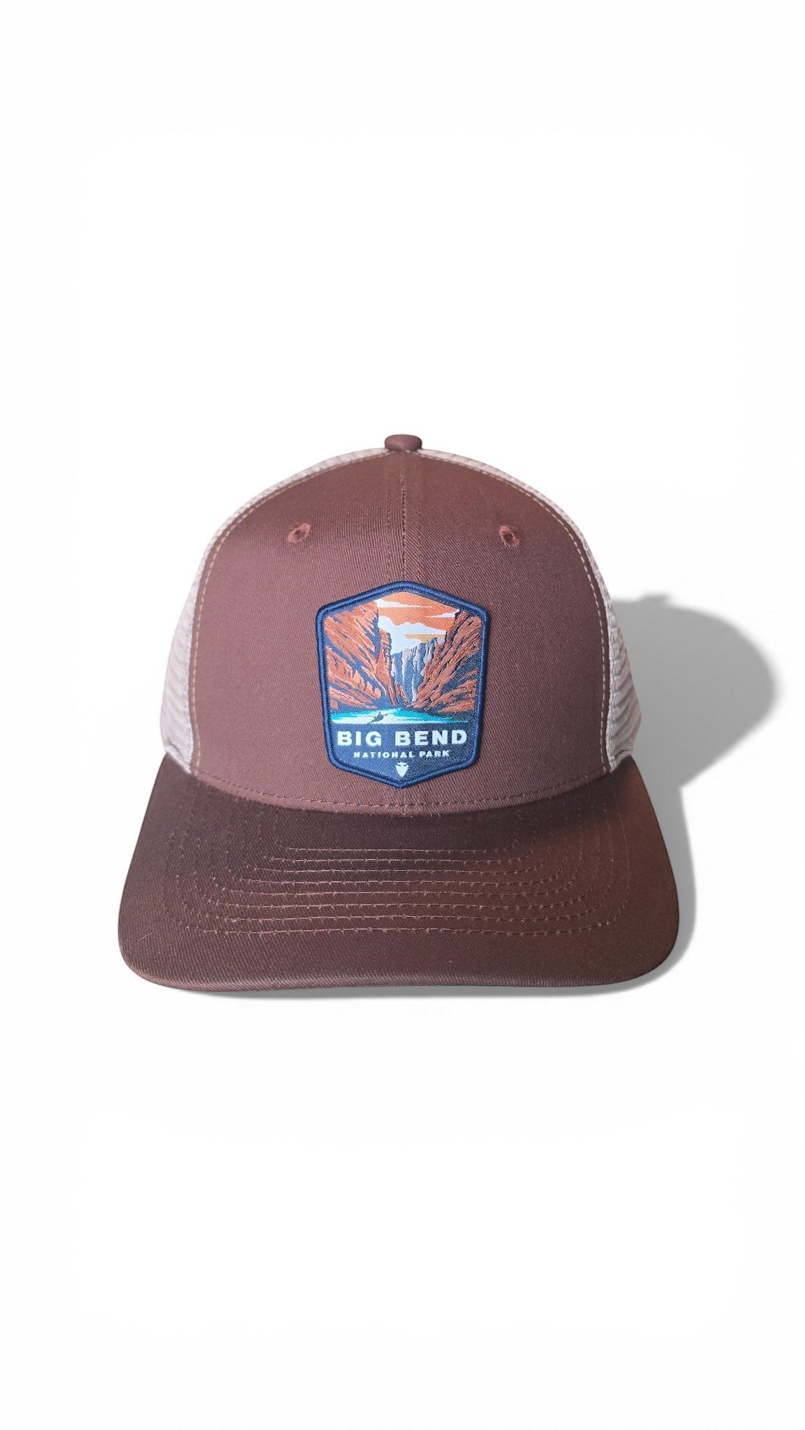 Moove Headwear Big Bend National Park trucker hat with brown front panels and white mesh back. Features a woven patch.