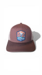 Moove Headwear Big Bend National Park trucker hat with brown front panels and white mesh back. Features a woven patch.