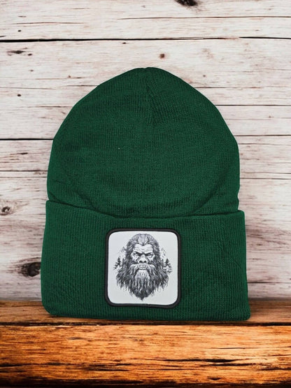 Moove Headwear dark green acrylic knit beanie with a Bigfoot patch. One size fits all.