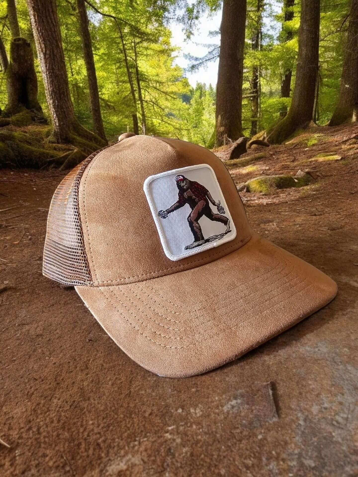 Moove Headwear tan suede trucker hat with Bigfoot patch and mesh back. Adjustable snapback for a secure fit.