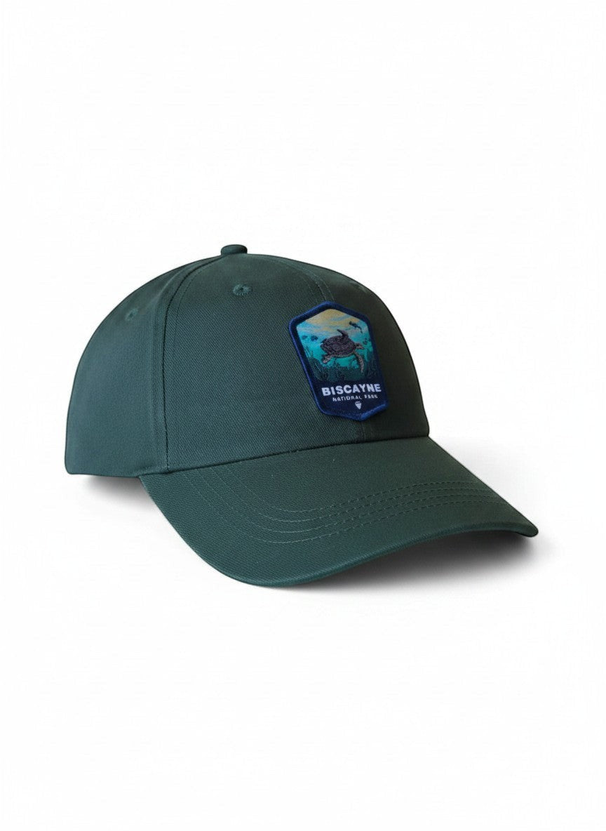 Moove Headwear dark green dad hat with Biscayne National Park embroidered patch featuring a sea turtle and coral.