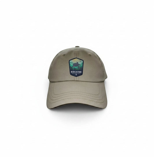 Moove Headwear tan baseball cap with Biscayne National Park embroidered patch featuring a sea turtle and mountains.