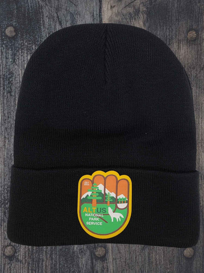 Moove Headwear black cuffed knit beanie with an AltUs National Park patch featuring mountain and forest graphics.
