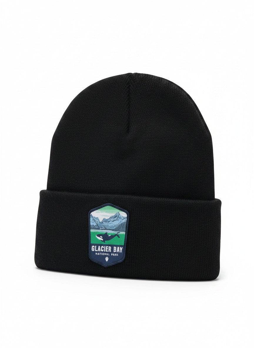 Moove Headwear black knit beanie with Glacier Bay National Park patch featuring mountains, water, and an orca whale.