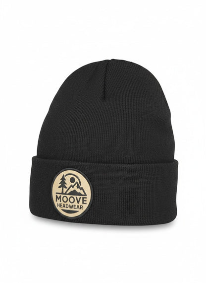 Moove Headwear black knit beanie with fold-over cuff and circular logo patch featuring mountains and trees.