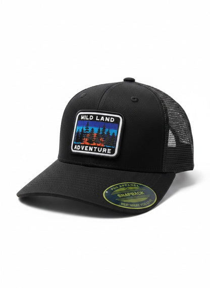 Moove Headwear black trucker hat with mesh back and "Wild Land Adventure" patch, adjustable snapback for outdoor hiking.