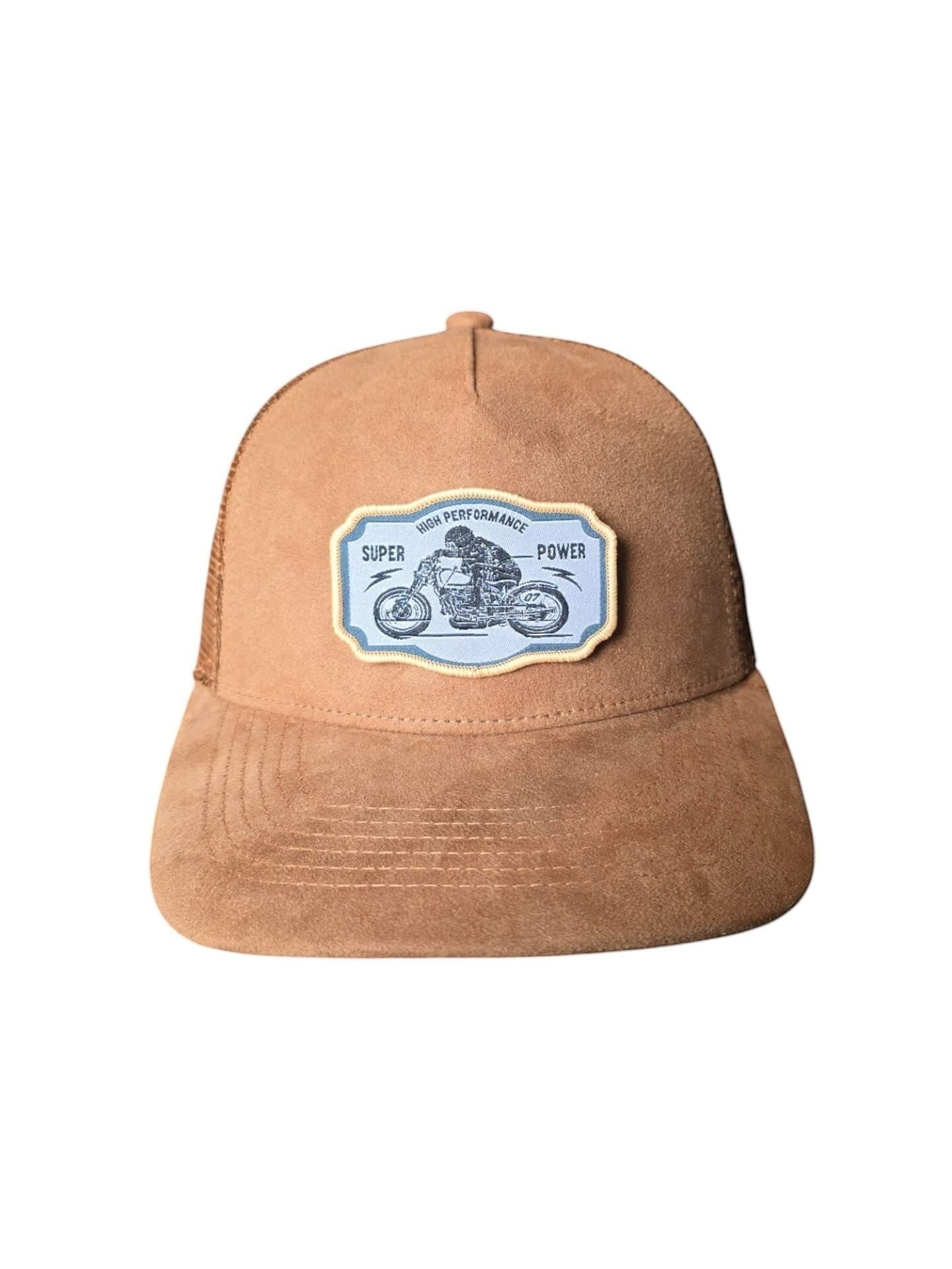 Moove Headwear brown suede trucker hat with mesh back and a patch featuring a motorcycle and text "Super Power High Performance".