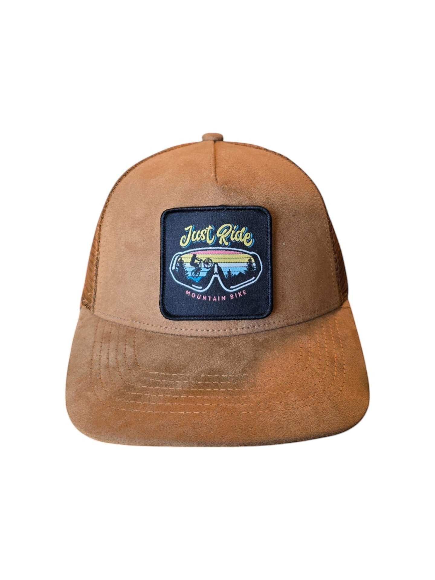Moove Headwear brown suede trucker hat with mesh back and "Just Ride Mountain Bike" patch.