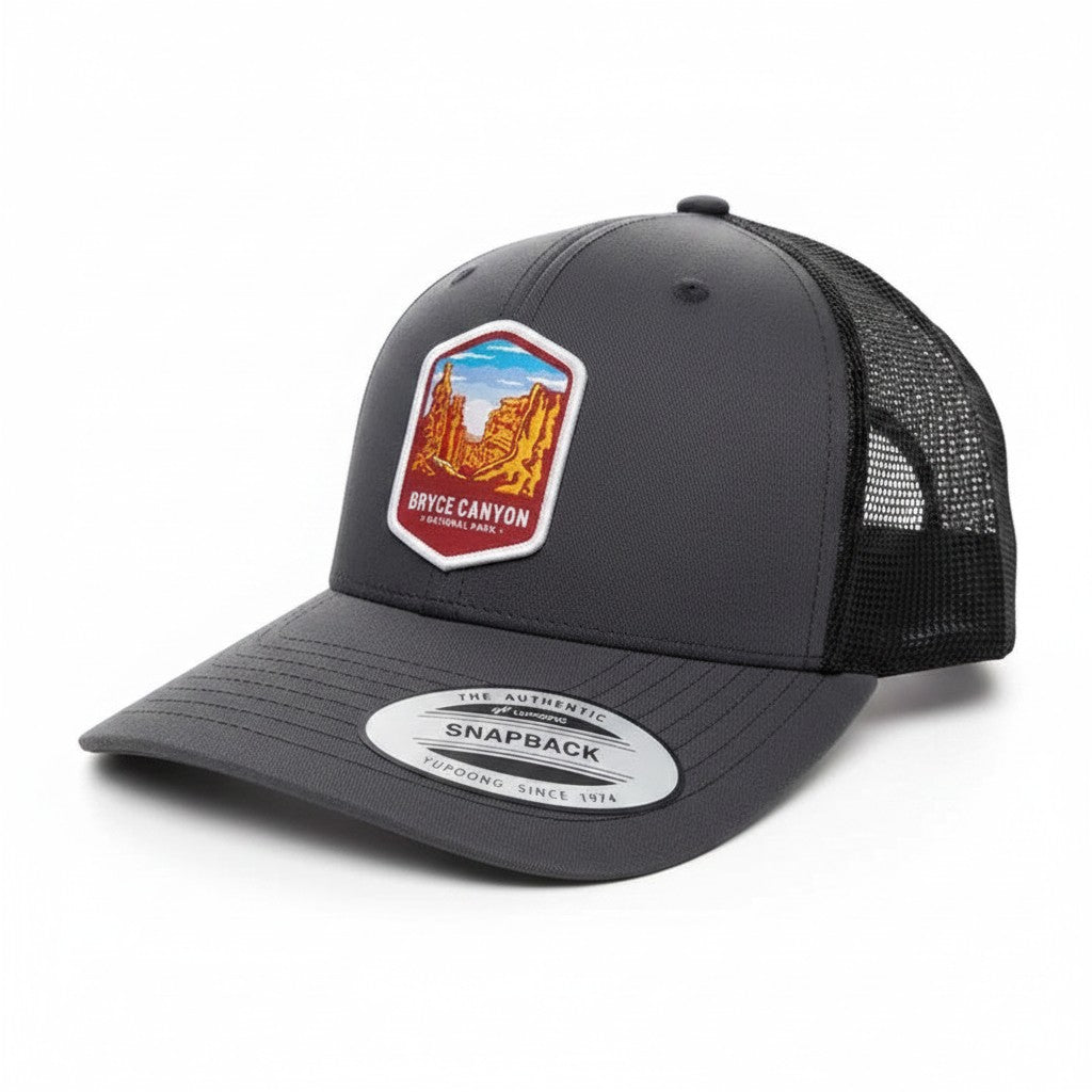 Moove Headwear dark grey trucker hat with Bryce Canyon National Park embroidered patch and mesh back. Adjustable snapback.