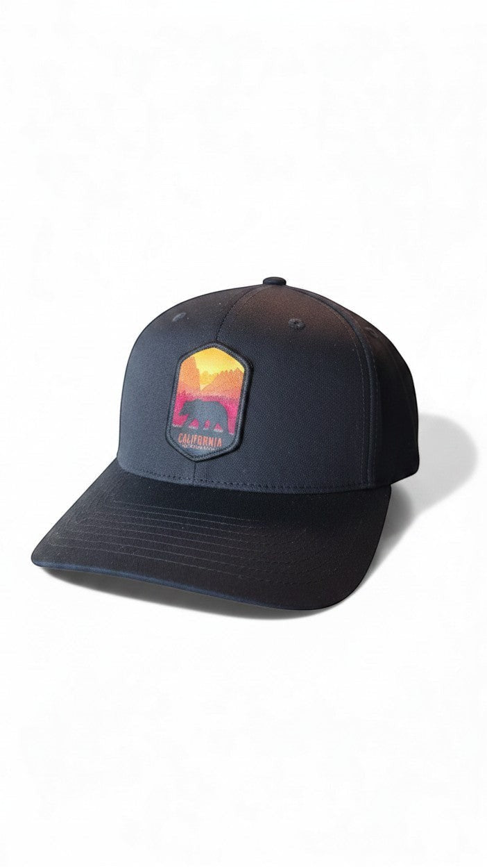 Moove Headwear black baseball cap with a California bear graphic patch featuring a sunset landscape.