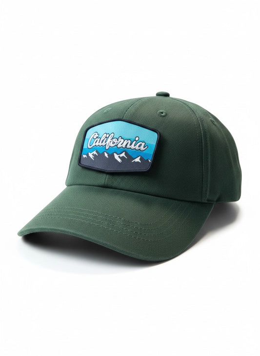 Moove Headwear dark green baseball cap with a woven patch depicting California mountains and trees. Adjustable fit.
