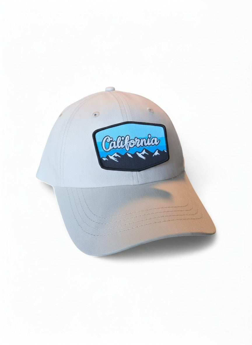 Moove Headwear light grey baseball cap with California mountains embroidered patch. Adjustable fit, ideal for hiking.