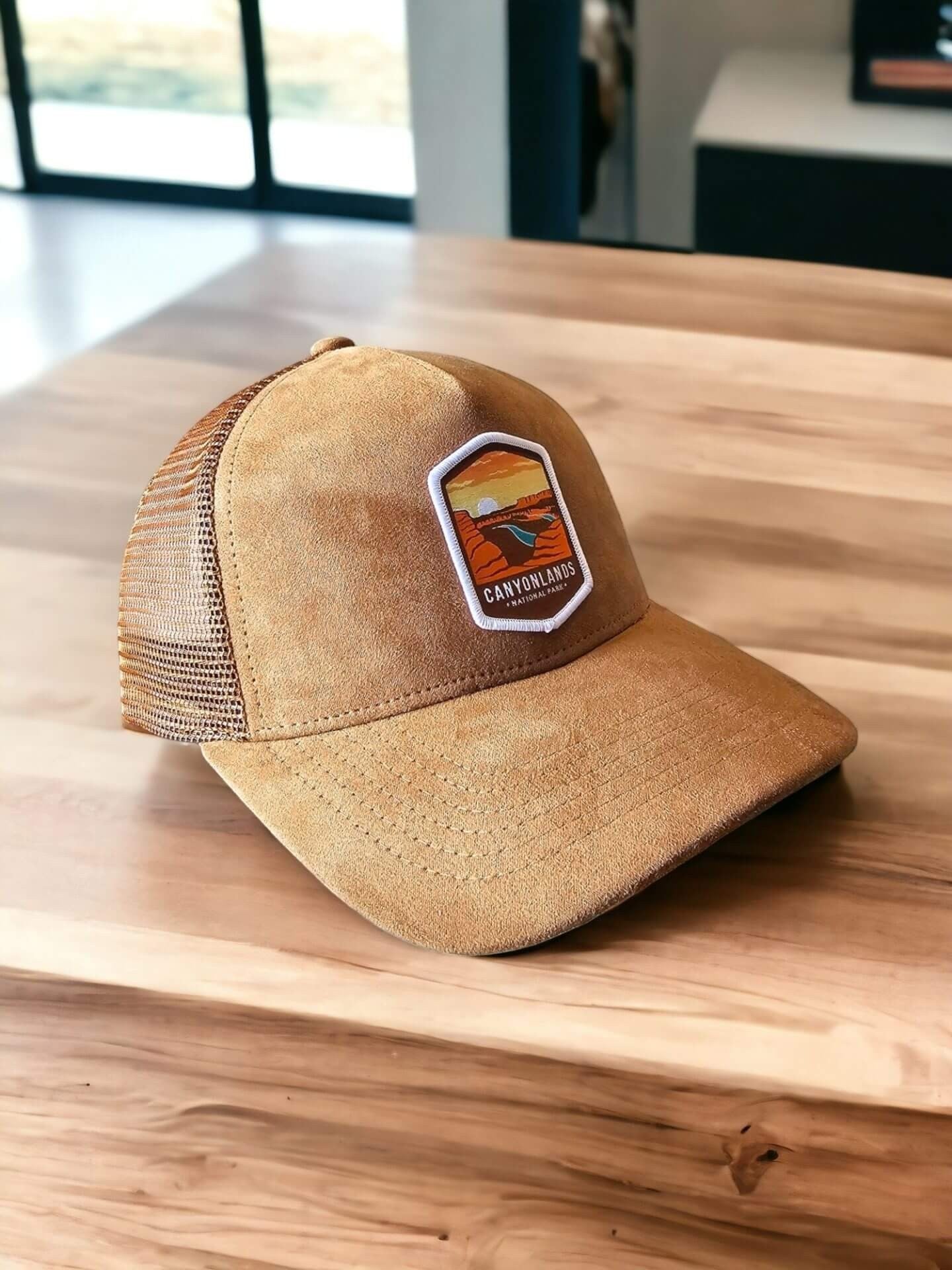 Moove Headwear tan suede trucker hat with mesh back and Canyonlands National Park patch. Adjustable snapback.